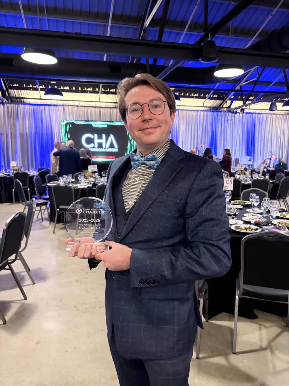Madison Kachel holding his award at the Chattanooga Area Chamber Annual Meeting.